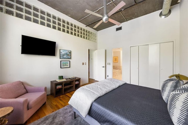 3235 Roswell Rd NE Unit 505, Atlanta, GA 30305 - bedroom with wood finished floors, a towering ceiling, a closet, ceiling fan, and connected bathroom