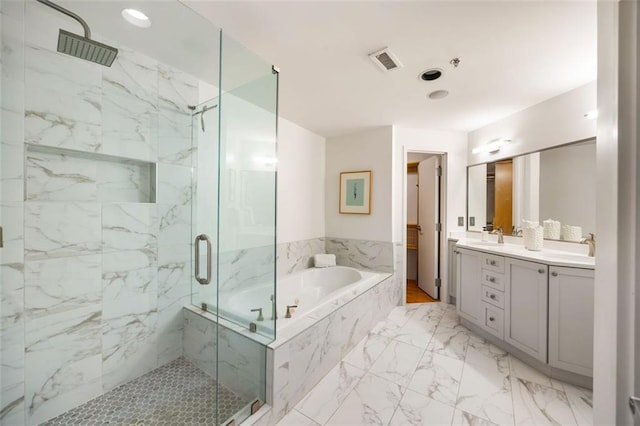 3235 Roswell Rd NE Unit 505, Atlanta, GA 30305 - bathroom featuring a marble finish shower, a garden tub, double vanity, and marble look tiles
