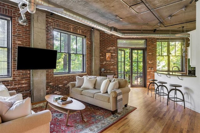 3235 Roswell Rd NE Unit 505, Atlanta, GA 30305 - living area with brick wall, plenty of natural light, and wood finished floors