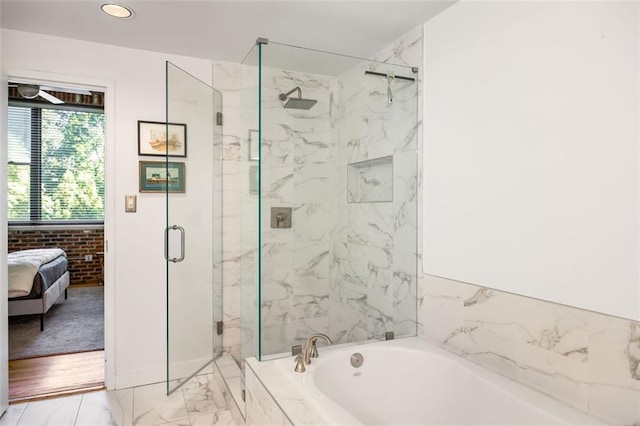 3235 Roswell Rd NE Unit 505, Atlanta, GA 30305 - bathroom with marble finish floors, a garden tub, a marble finish shower, ensuite bath, and recessed lighting