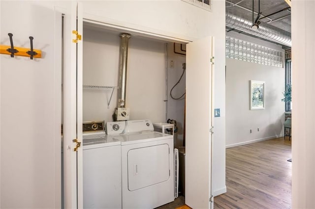 3235 Roswell Rd NE Unit 505, Atlanta, GA 30305 - laundry room with washing machine and dryer, wood finished floors, and baseboards