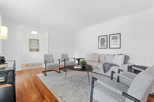 living room featuring crown molding and hardwood / wood-style flooring