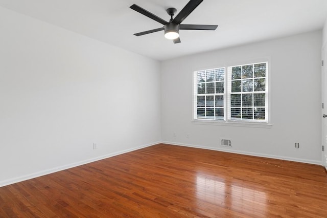 empty room featuring hardwood / wood-style floors and ceiling fan