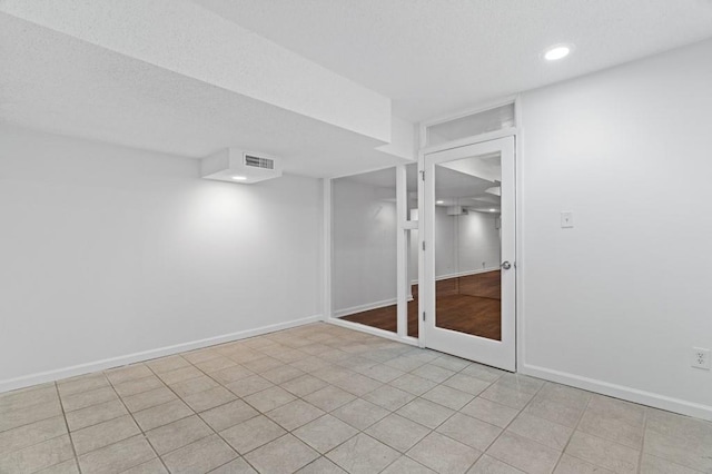 unfurnished room featuring a textured ceiling