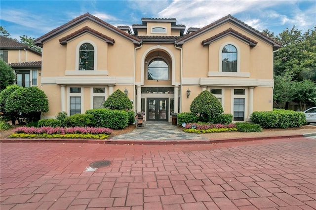 mediterranean / spanish home featuring french doors