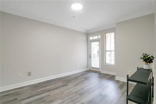 entryway with hardwood / wood-style flooring and crown molding