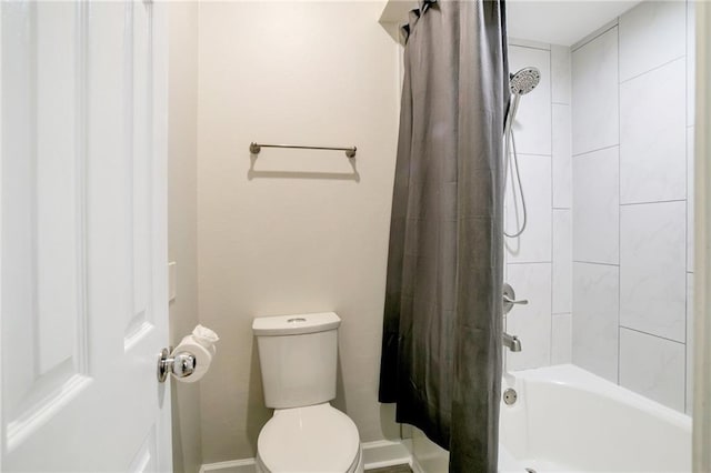 bathroom featuring shower / bath combination with curtain and toilet