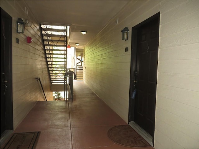 corridor featuring wood walls