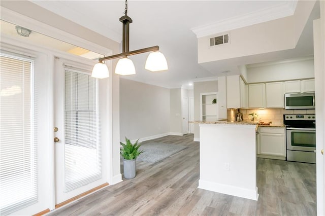 kitchen featuring light stone counters, pendant lighting, decorative backsplash, white cabinets, and appliances with stainless steel finishes