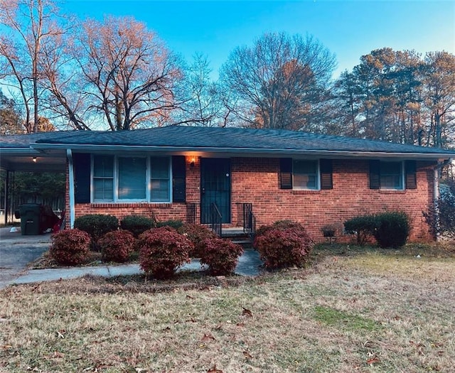 ranch-style house with a carport and a front yard