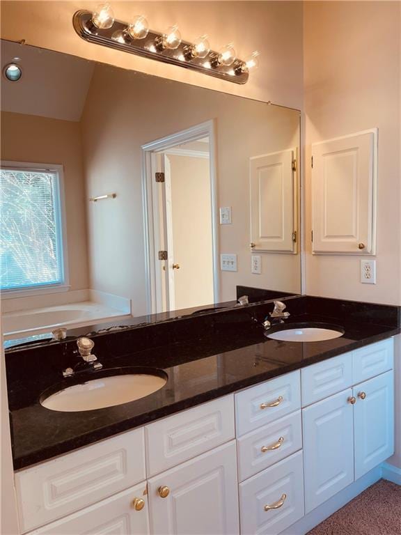 bathroom featuring double vanity and a sink