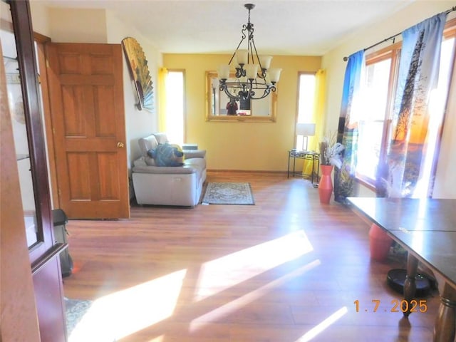 playroom with hardwood / wood-style floors and a notable chandelier