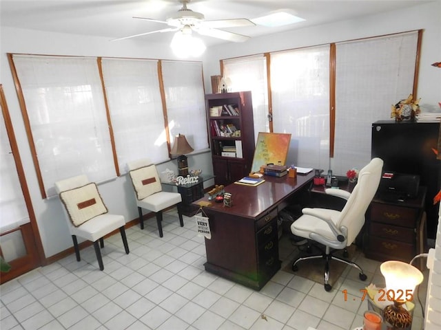 office area with light tile patterned floors and ceiling fan