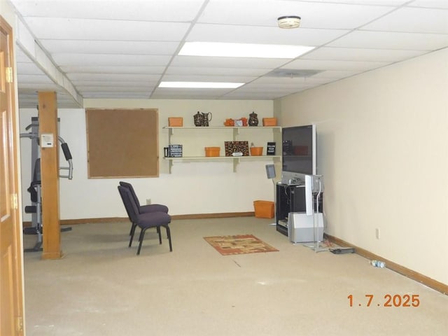 basement with a paneled ceiling