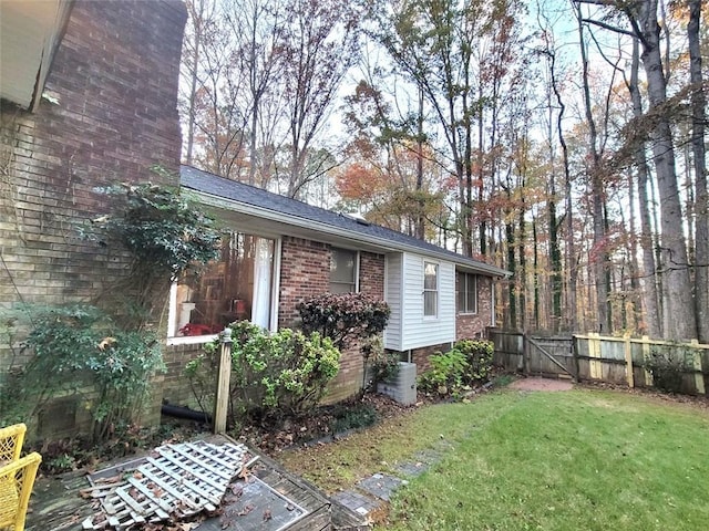 view of side of home featuring a yard