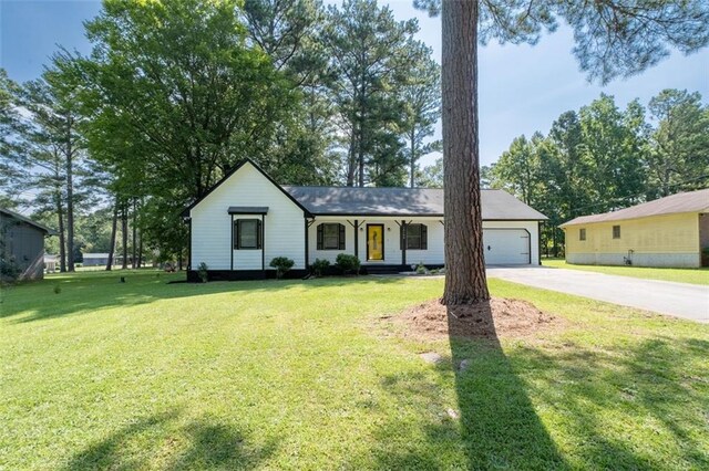 single story home featuring a front lawn and a garage