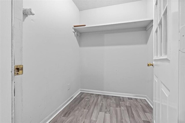 laundry area featuring hardwood / wood-style floors and a textured ceiling