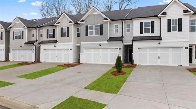 321 Sound Cir, Stockbridge, GA 30281 - view of property with a garage, a standing seam roof, a metal roof, driveway, and board and batten siding