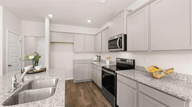321 Sound Cir, Stockbridge, GA 30281 - kitchen with stainless steel appliances, dark wood-type flooring, light stone counters, and recessed lighting