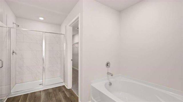 321 Sound Cir, Stockbridge, GA 30281 - full bathroom with a garden tub, a stall shower, wood finished floors, and a walk in closet