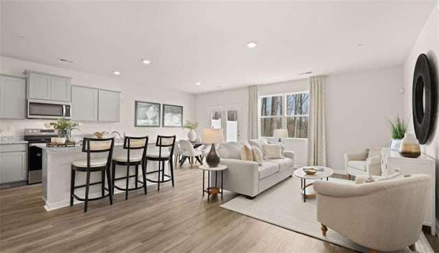 321 Sound Cir, Stockbridge, GA 30281 - living room featuring wood finished floors and recessed lighting