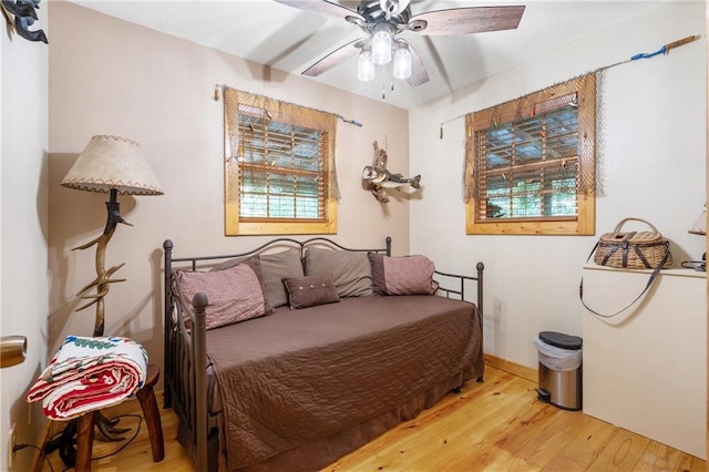 bedroom with ceiling fan and wood finished floors