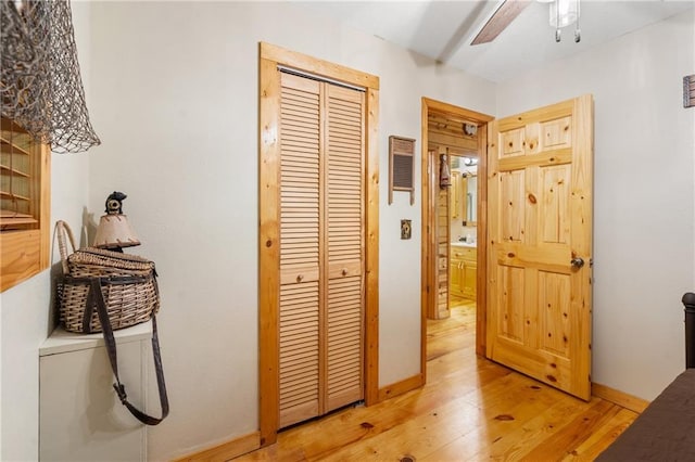 hallway with baseboards and light wood finished floors