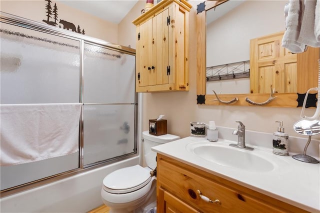 full bathroom with enclosed tub / shower combo, toilet, and vanity