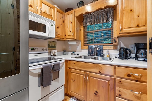 kitchen featuring a sink, white appliances, and light countertops