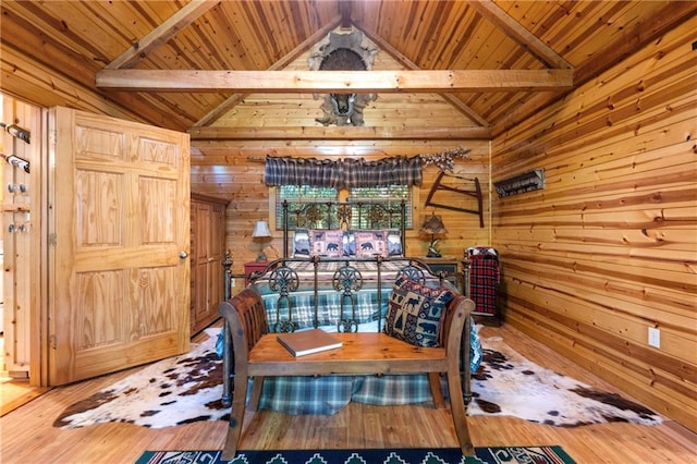 dining area featuring hardwood / wood-style floors, vaulted ceiling, wooden walls, and wood ceiling