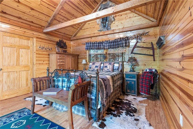 bedroom with high vaulted ceiling, wood-type flooring, wood walls, wooden ceiling, and beamed ceiling