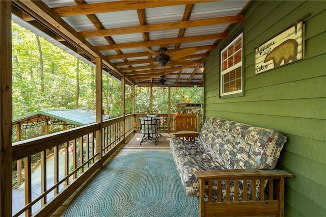 wooden terrace with covered porch and ceiling fan