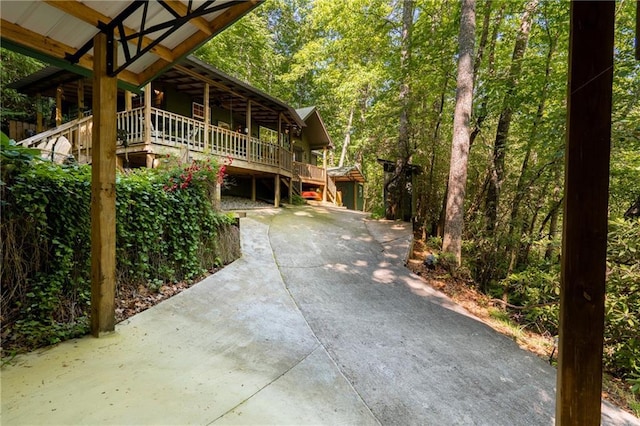 view of side of home with a wooded view