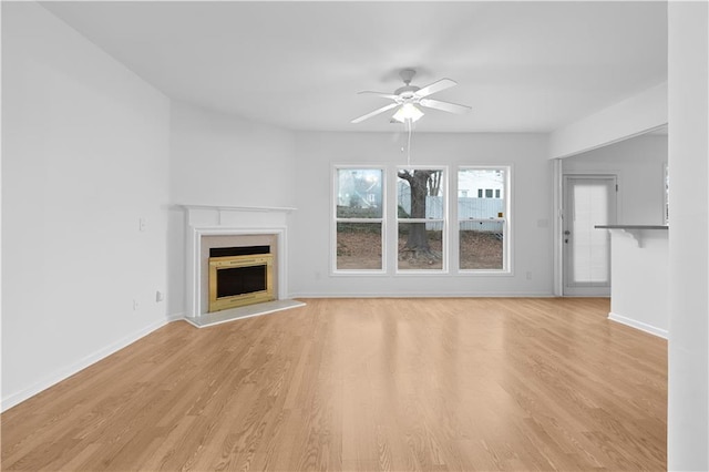 unfurnished living room with light hardwood / wood-style flooring and ceiling fan