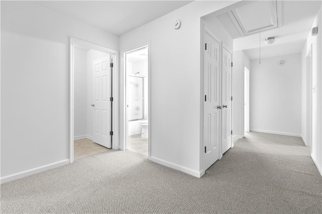 hall featuring light colored carpet