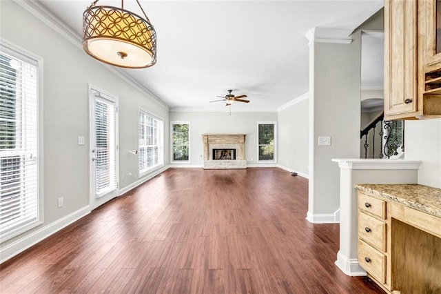 unfurnished living room with ornamental molding, dark hardwood / wood-style floors, and ceiling fan