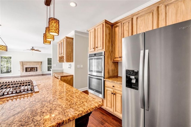 kitchen featuring stainless steel appliances, ornamental molding, light stone countertops, pendant lighting, and dark hardwood / wood-style flooring