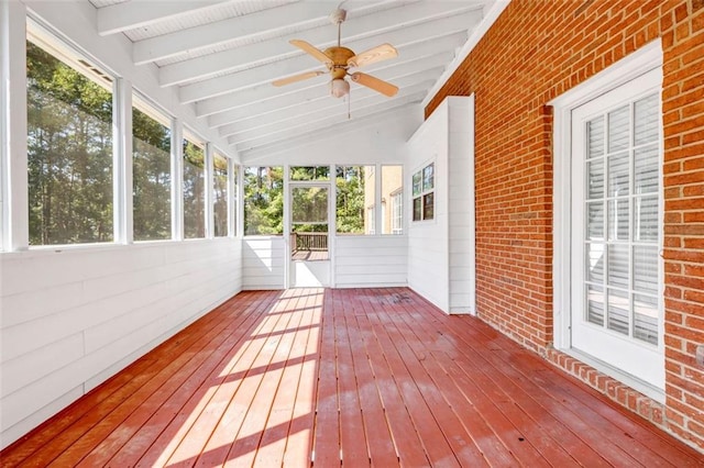 unfurnished sunroom featuring vaulted ceiling with beams and ceiling fan