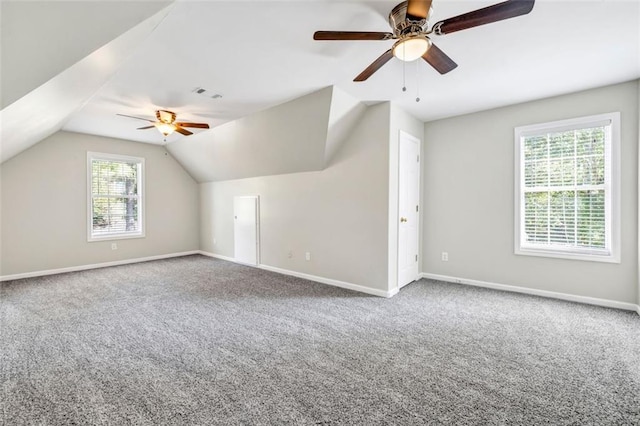 bonus room with vaulted ceiling, carpet flooring, and ceiling fan