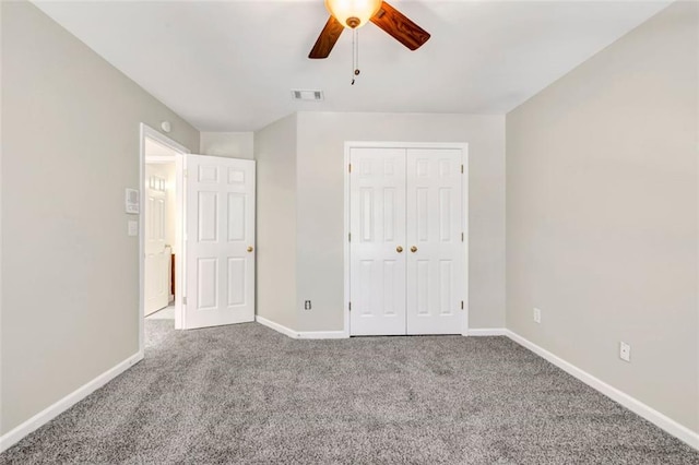 unfurnished bedroom with a closet, ceiling fan, and carpet flooring