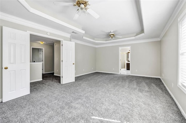 carpeted empty room featuring ornamental molding, ceiling fan, and a raised ceiling