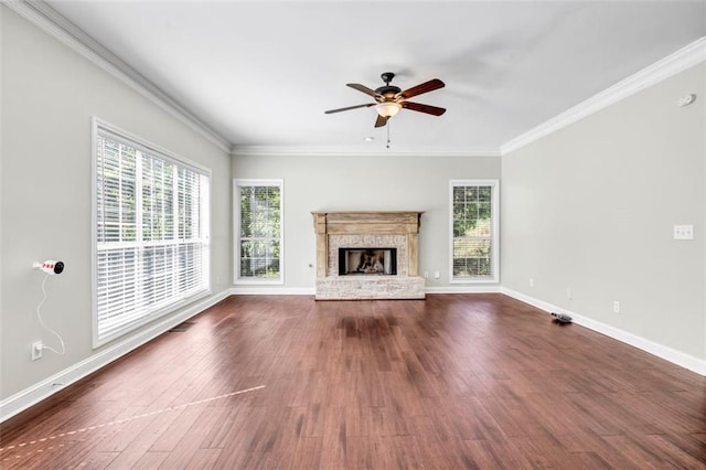 unfurnished living room with ornamental molding, a brick fireplace, dark hardwood / wood-style floors, and ceiling fan