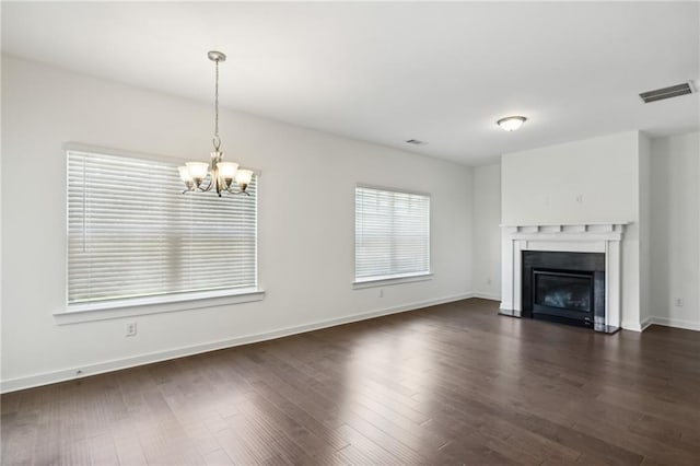 1637 Short Shadow Ln, Snellville, GA 30078 - unfurnished living room with a chandelier, a fireplace with flush hearth, and dark wood finished floors