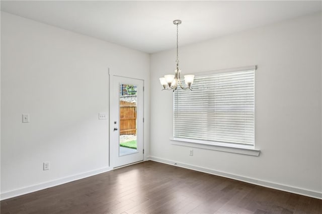 1637 Short Shadow Ln, Snellville, GA 30078 - spare room featuring a chandelier and dark wood-style floors