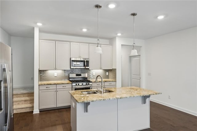 1637 Short Shadow Ln, Snellville, GA 30078 - kitchen with stainless steel appliances, dark wood-style floors, decorative backsplash, light stone counters, and a kitchen bar