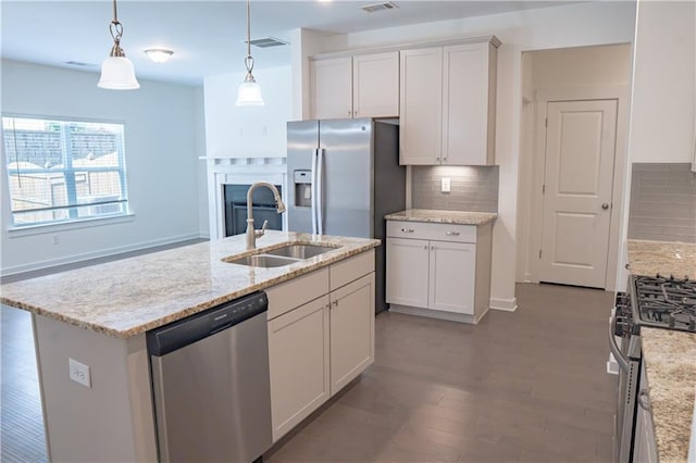 1637 Short Shadow Ln, Snellville, GA 30078 - kitchen featuring appliances with stainless steel finishes, tasteful backsplash, white cabinetry, and hanging light fixtures