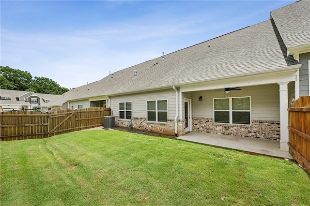 1637 Short Shadow Ln, Snellville, GA 30078 - back of property featuring a ceiling fan, a patio area, a fenced backyard, brick siding, and roof with shingles