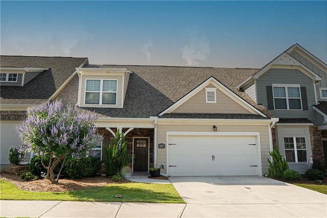 1637 Short Shadow Ln, Snellville, GA 30078 - craftsman-style home with driveway, an attached garage, and a shingled roof
