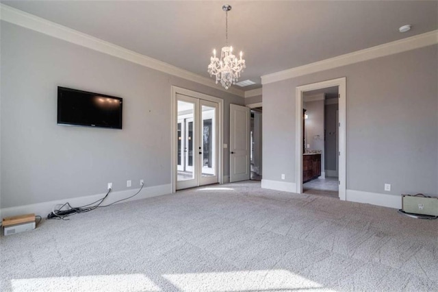 unfurnished living room featuring ornamental molding, light carpet, a chandelier, and french doors