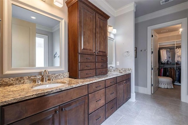 bathroom featuring tile patterned floors, ornamental molding, and vanity